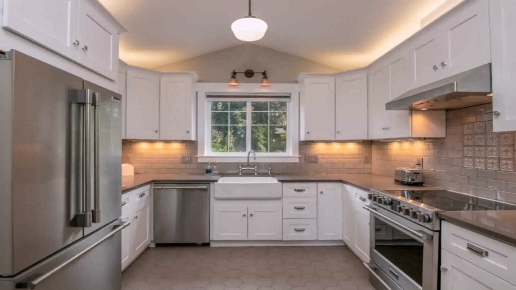 a kitchen with white cabinets and stainless steel appliances